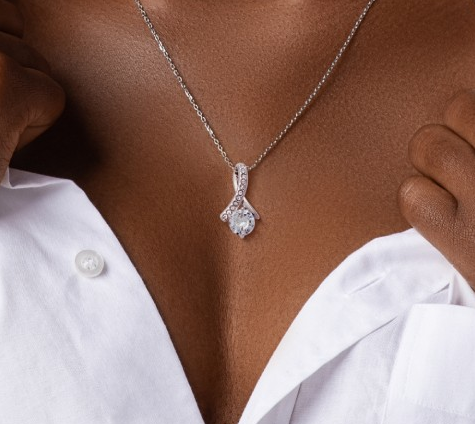 Diamond necklace on a person wearing a white shirt